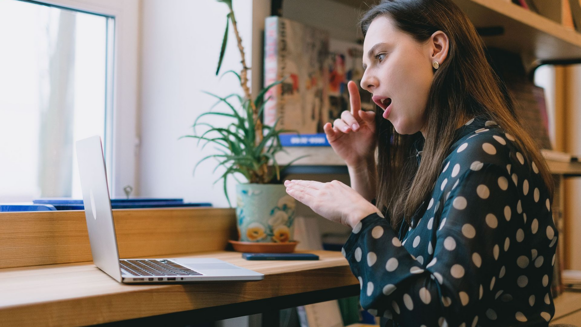 Woman communicating in American Sign Language during an online video counseling session