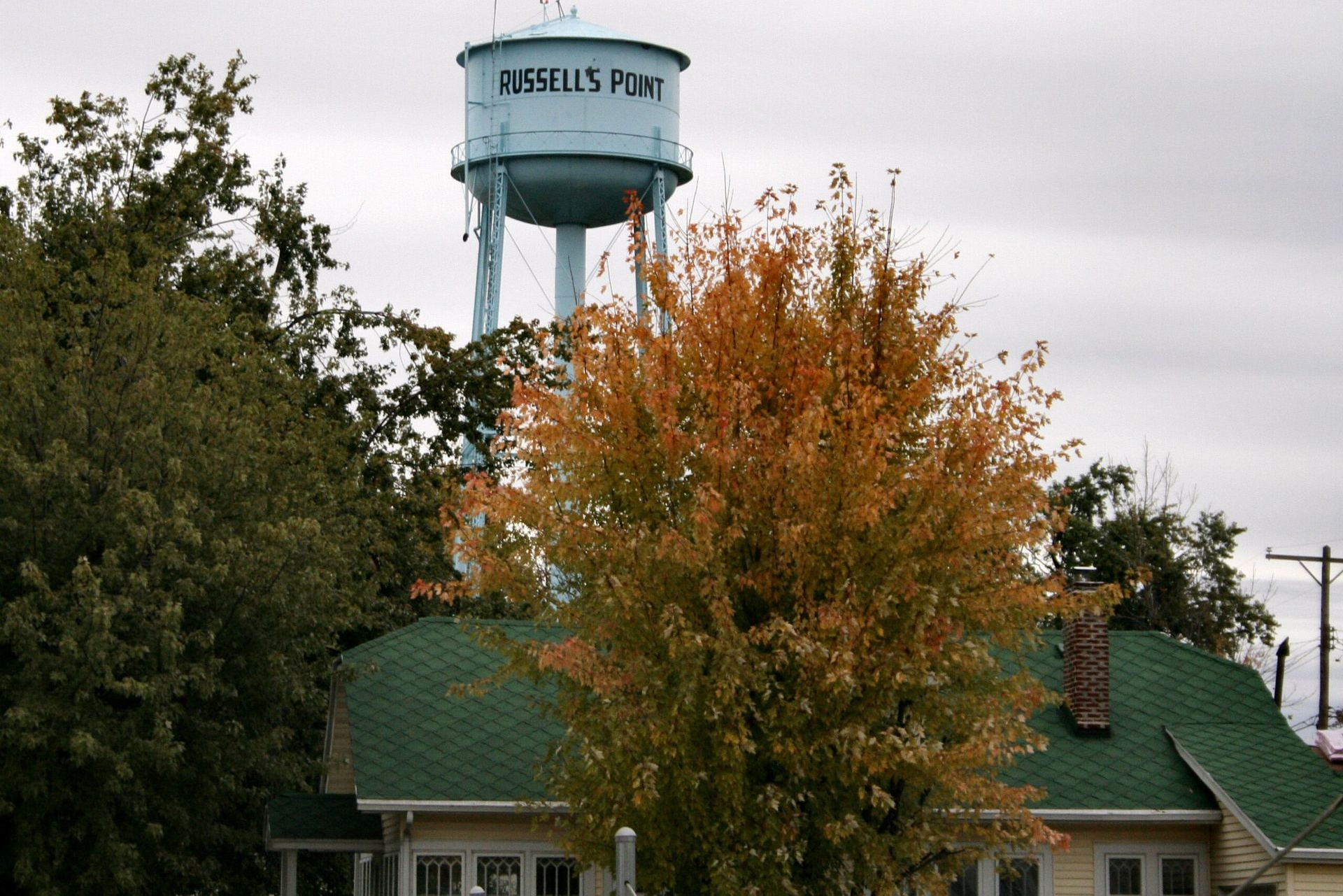 A blue water tower labeled