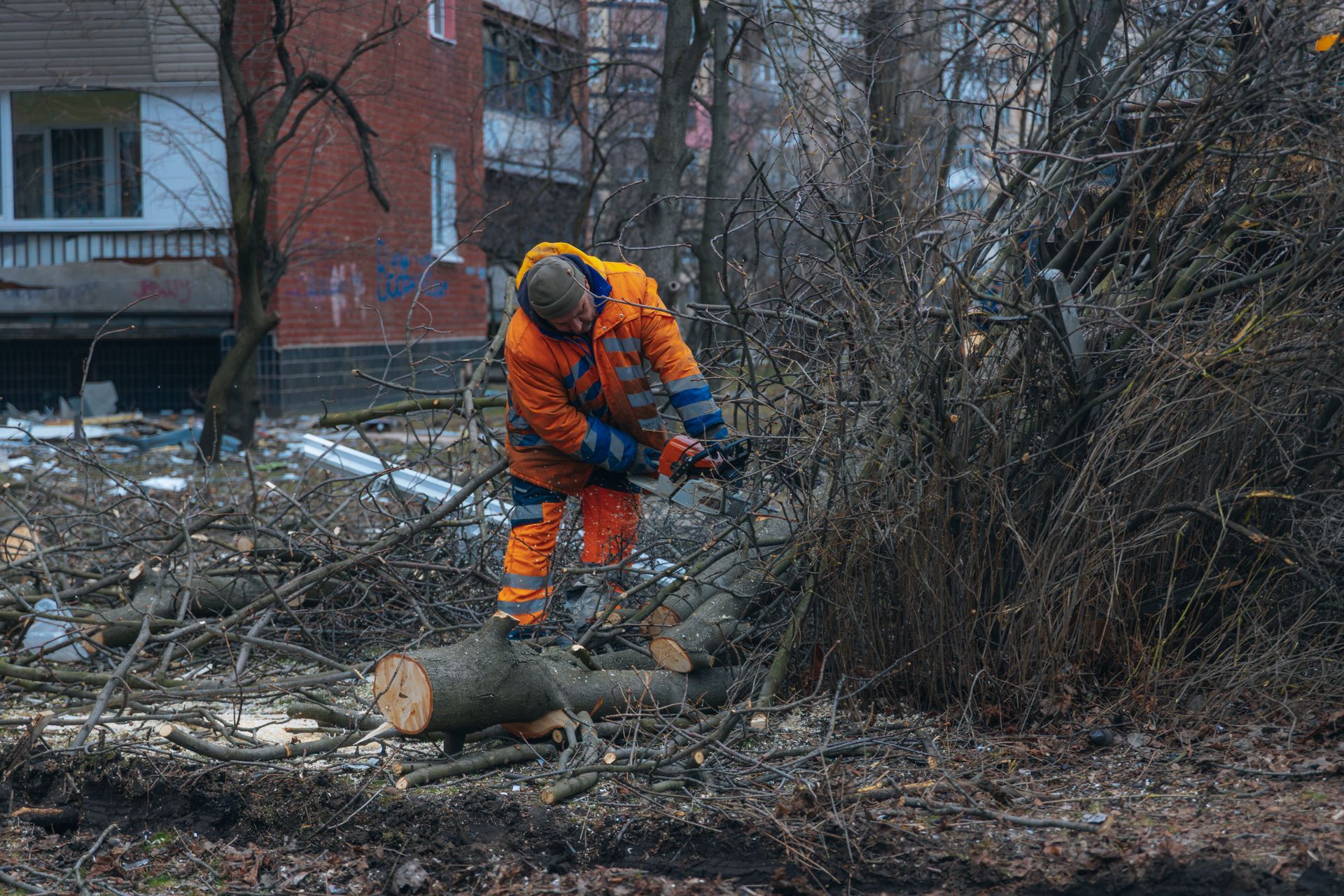 Cleanup process and recovery work in a residential area after an urban disaster or storm.