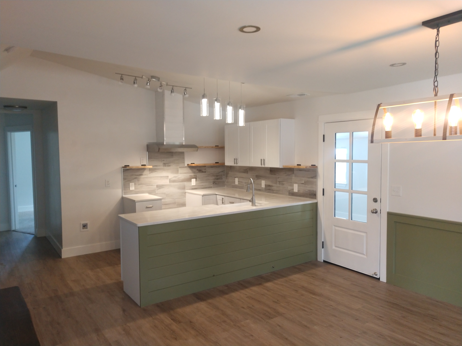 Kitchen with Grey Tile Backsplash, White Cabinets, Custom Solid Wood Shelving, and Green Board and Batten