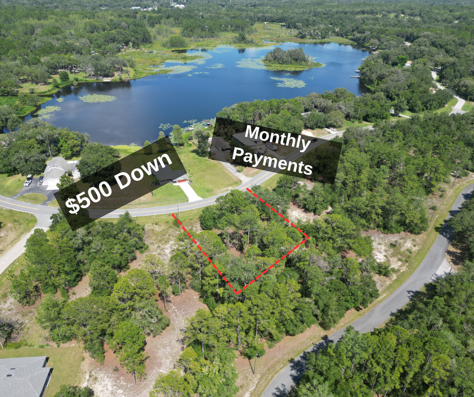 Aerial view of a wooded lot for sale near a lake with text overlay: 