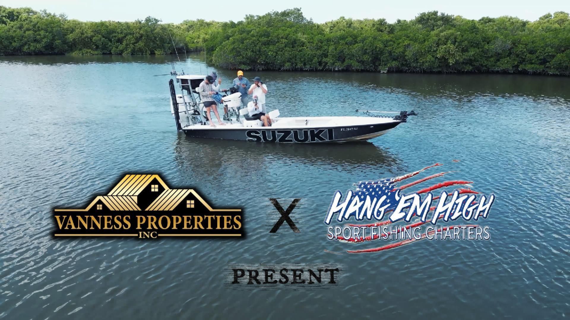 Boat with people fishing in a waterway, trees in background, Suzuki logo, and sponsor logos for Vanness Properties and Hang 'Em High Outfitters.