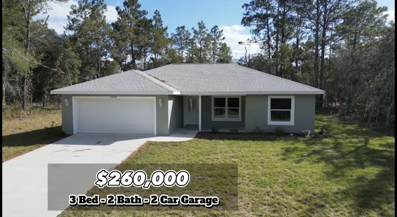 House exterior with a price tag of $260,000. Features 3 beds, 2 baths, and a 2-car garage. Set in a grassy yard.
