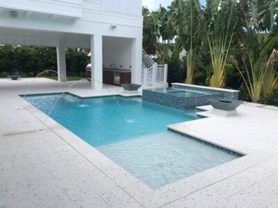 A large swimming pool in the backyard of a house