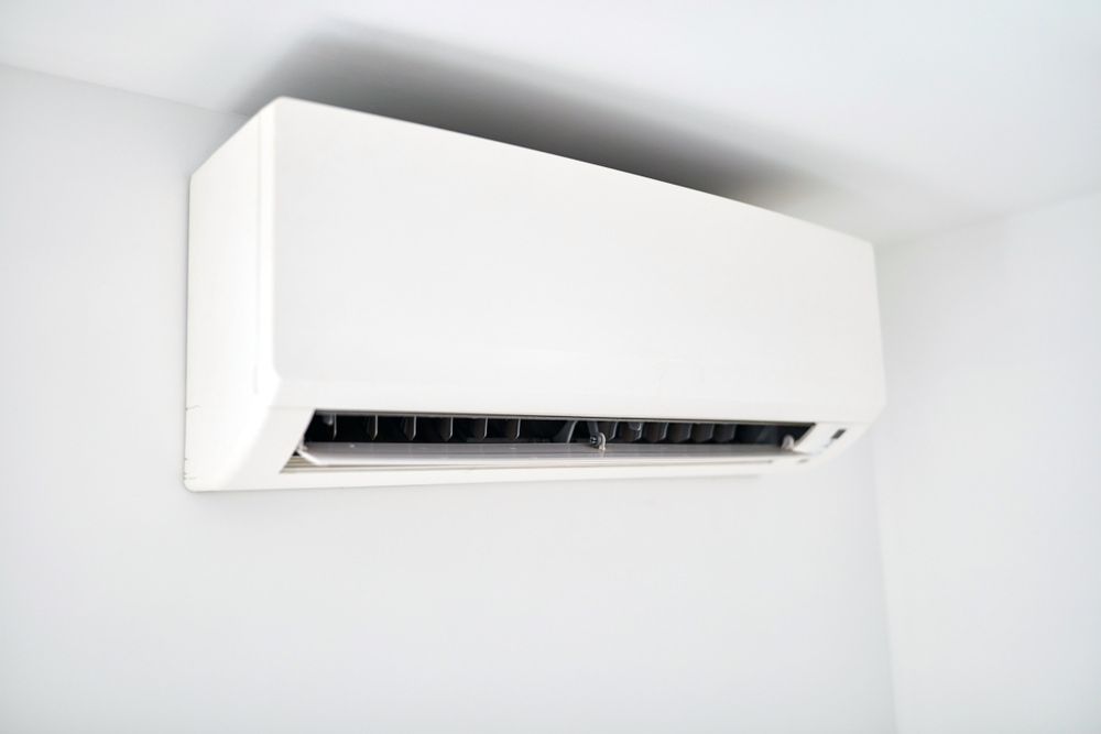 White Air Conditioning Unit Mounted on a White Wall — Frosty Solutions Air Conditioning In Mudgee, NSW