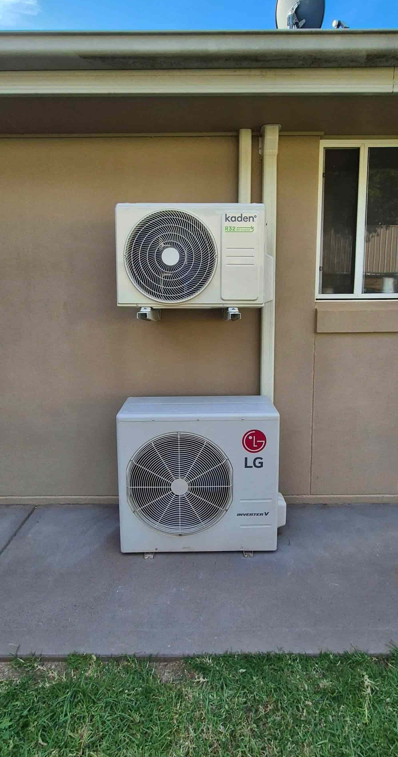 Two Air Conditioning Units Mounted on a Beige Building Exterior — Frosty Solutions Air Conditioning In Ulan, NSW