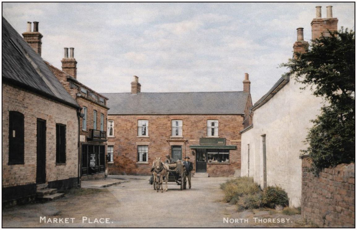 Vintage village square with brick buildings, horse cart, and “Market Place” and “North Terrace” signs