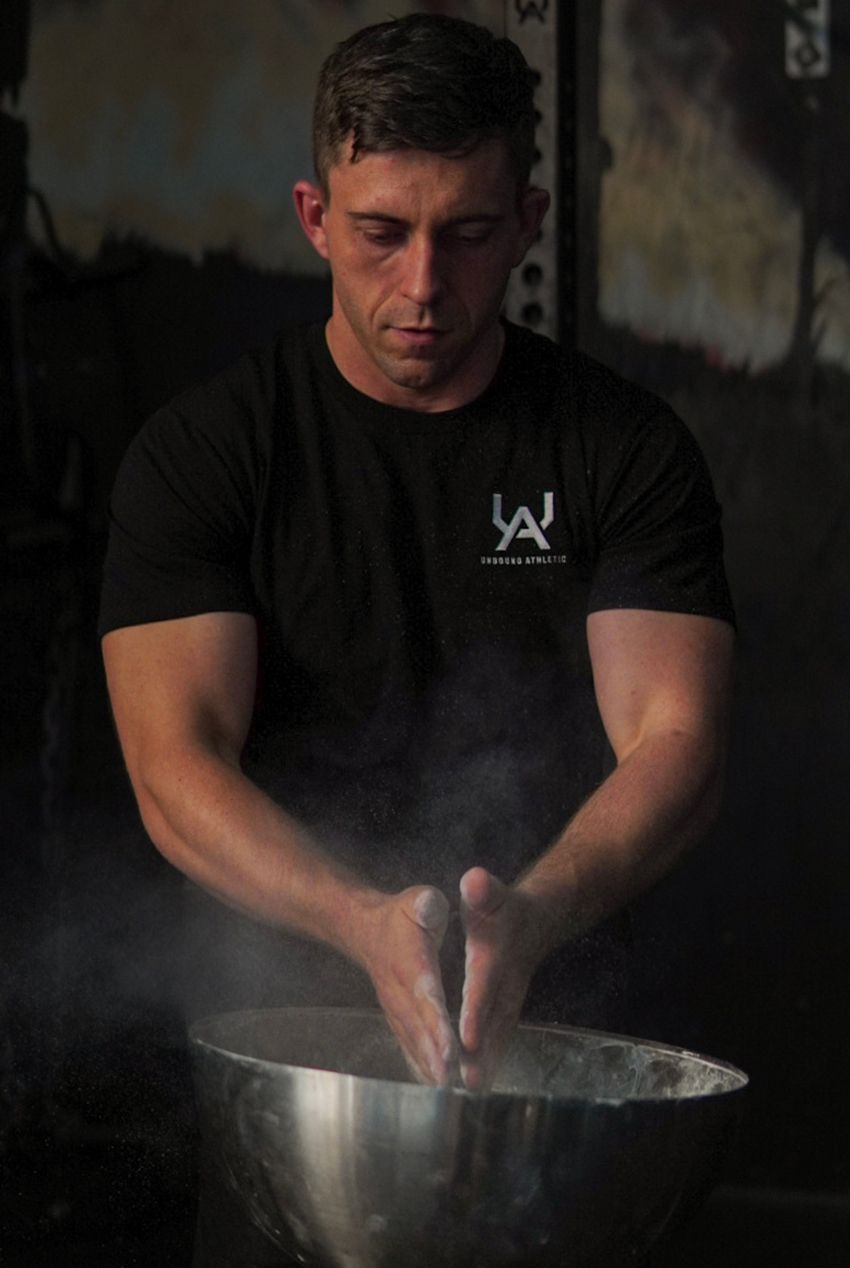 Michael Earl  lifting a barbell over his head