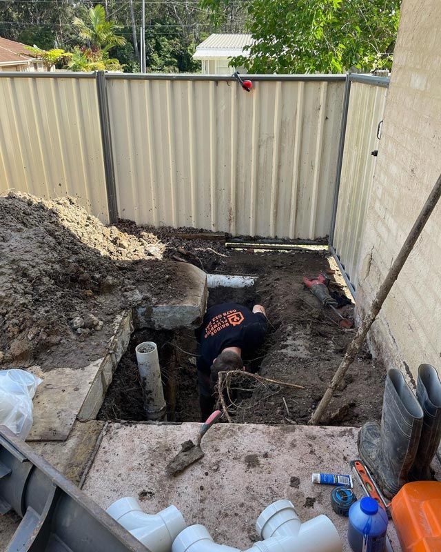 A Man Performing Plumbing Service In A Drainage — Bridge Plumbing & Trades in Shoalhaven, NSW