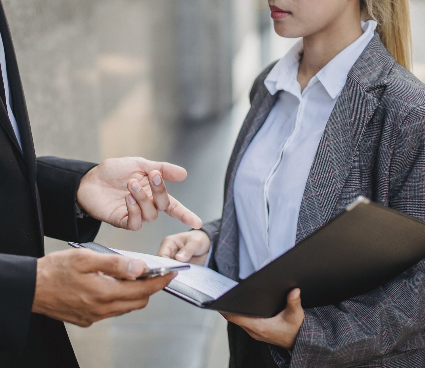 Two people discussing documents