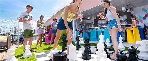 Children playing giant chess outdoors at a colorful backyard party