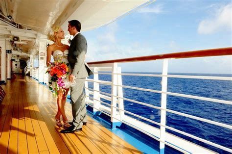 A couple embracing on a cruise ship deck with an ocean view and blue sky