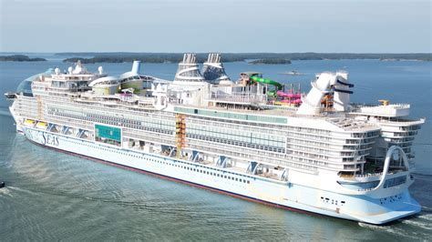 Large white cruise ship sailing on calm blue water under a clear sky