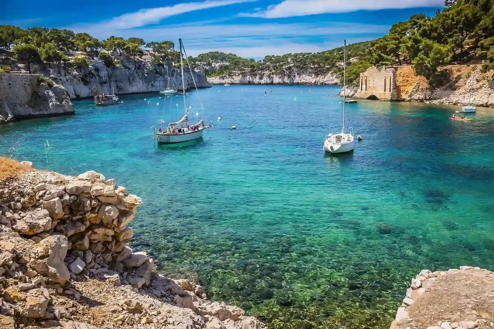 A group of boats are floating on top of a body of water.