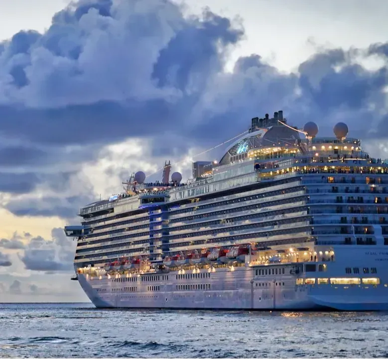 A large cruise ship is floating on top of a body of water