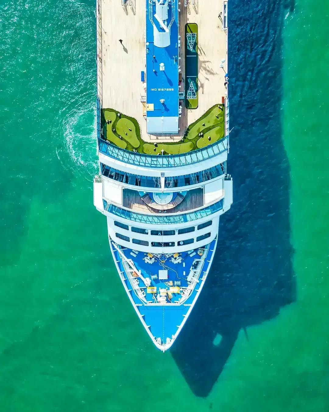 An aerial view of a cruise ship in the ocean.