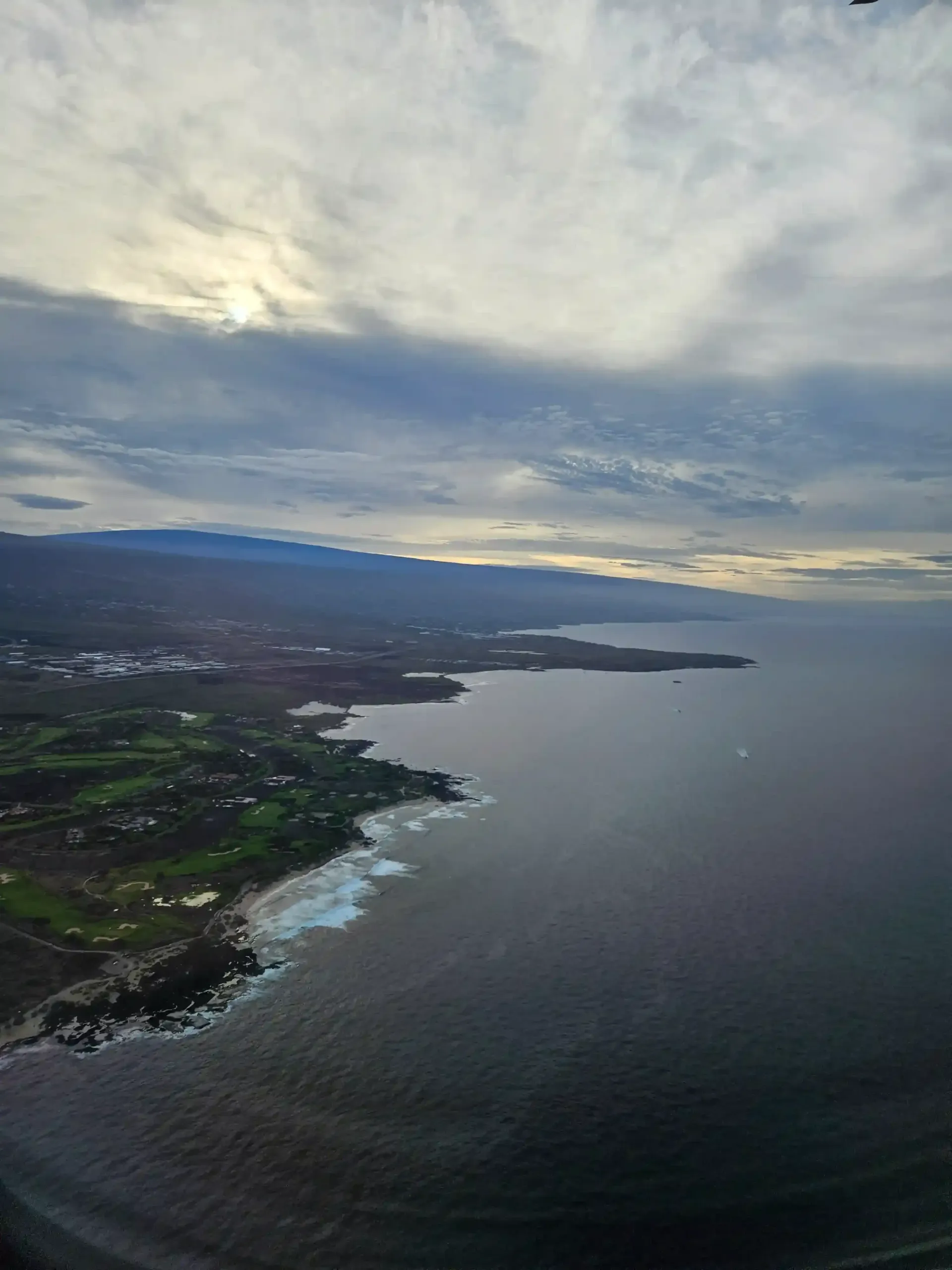 An aerial view of a body of water with mountains in the background
