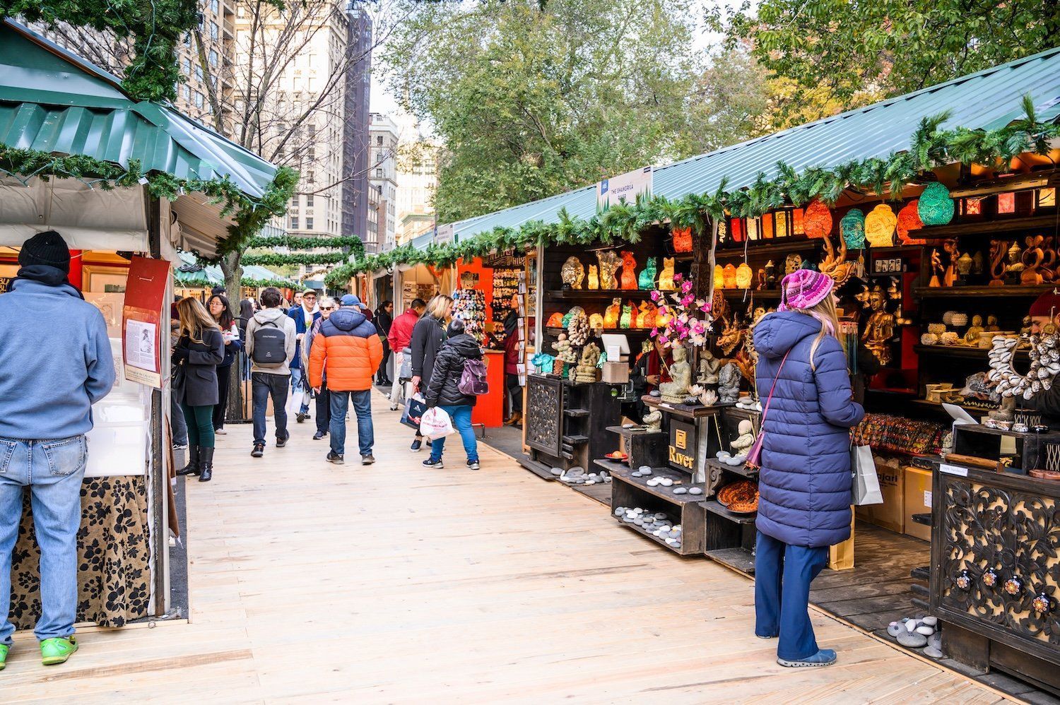A group of people is shopping at a Christmas market.