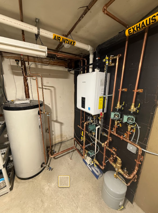 Utility room with water heater, boiler, exposed copper pipes, and labeled air intake/exhaust ducts