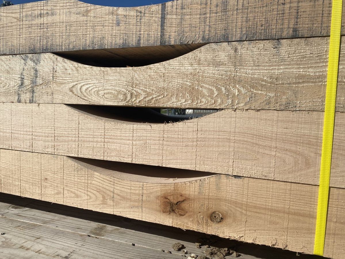 A close up of a piece of wood with a measuring tape.