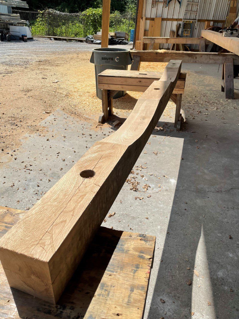 A piece of wood with a hole in it is sitting on a table.