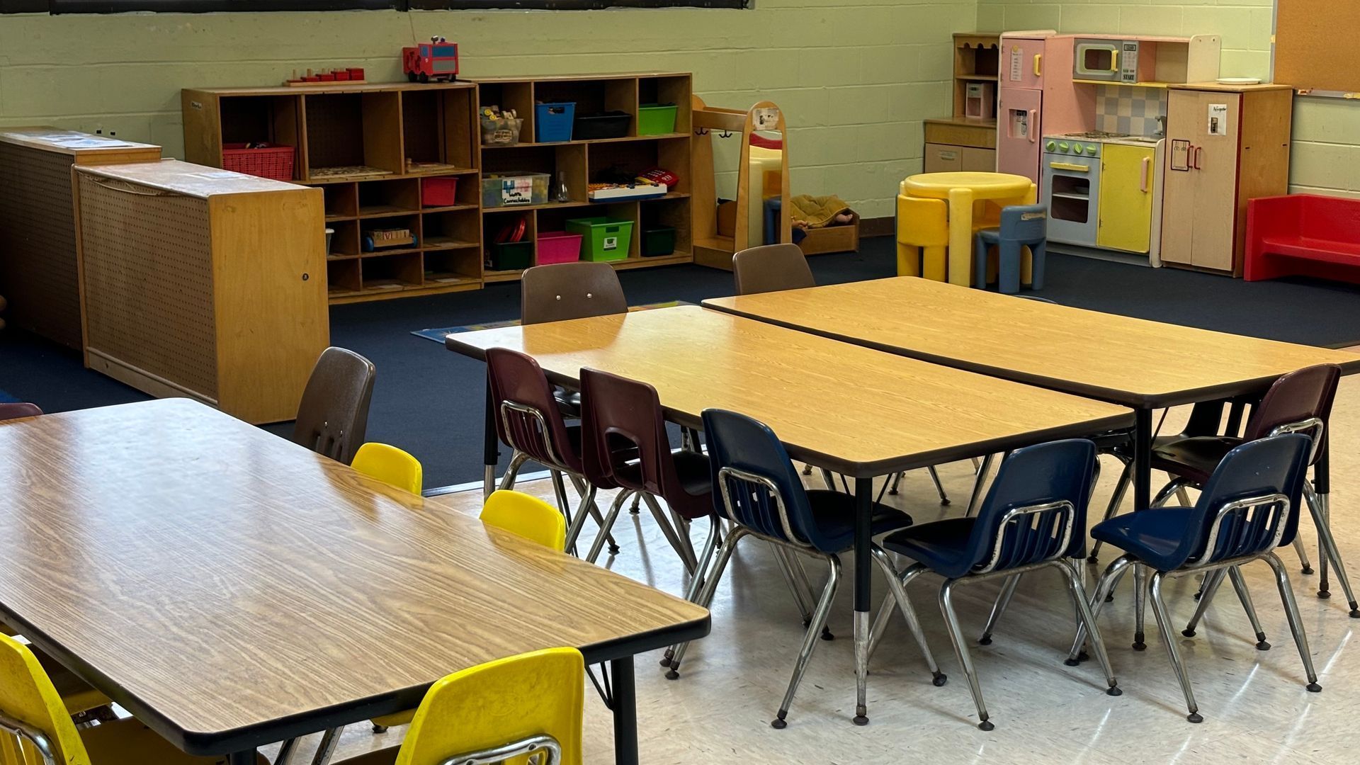 A classroom with tables and chairs in it