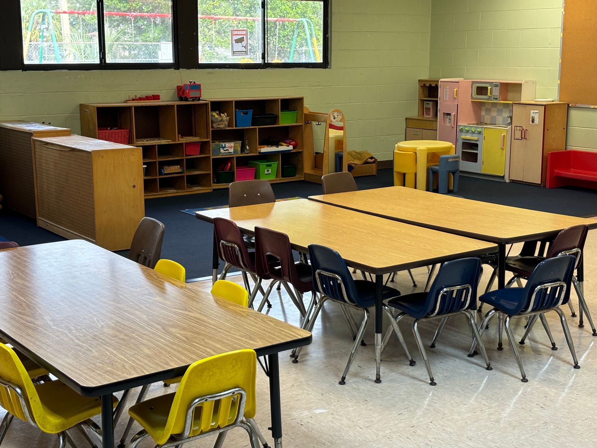 A classroom with tables and chairs in it
