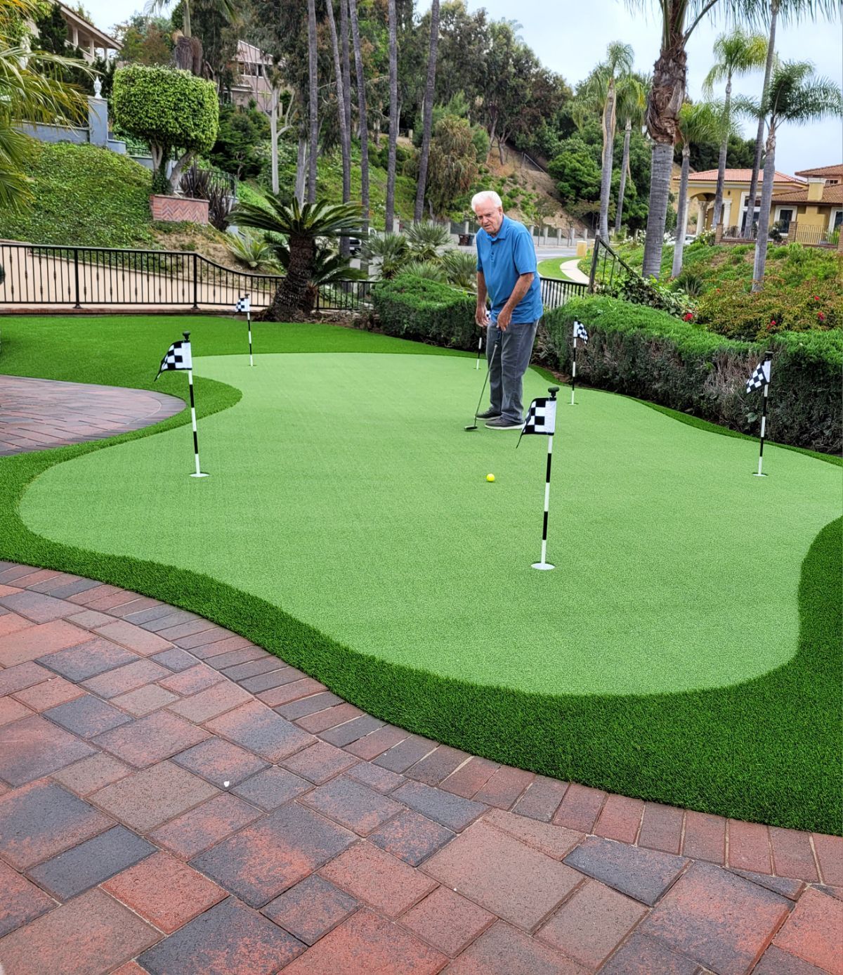 Man on synthetic putting ggreen