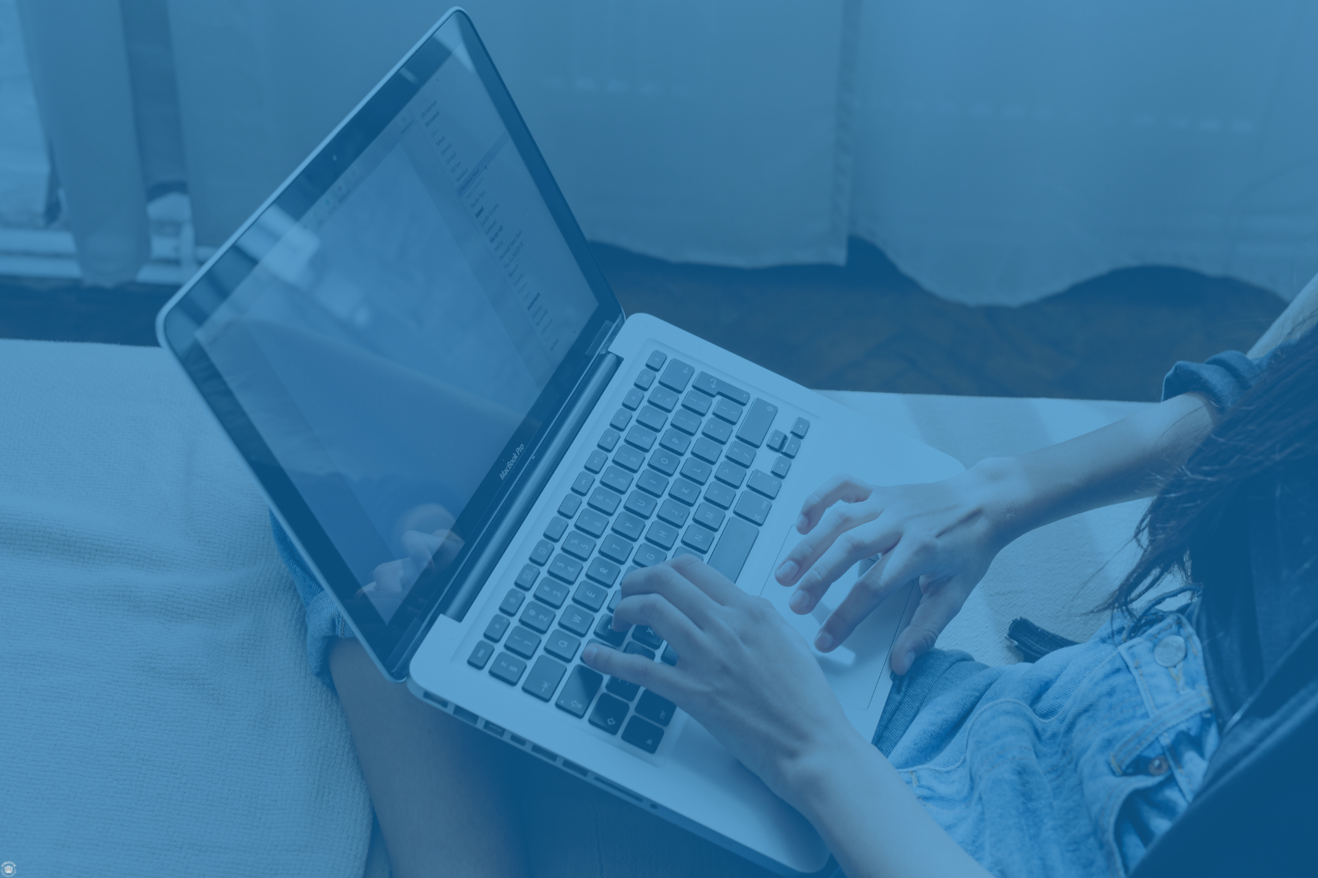 Person working on a laptop representing telecom cost analysis and multi-location pricing comparisons