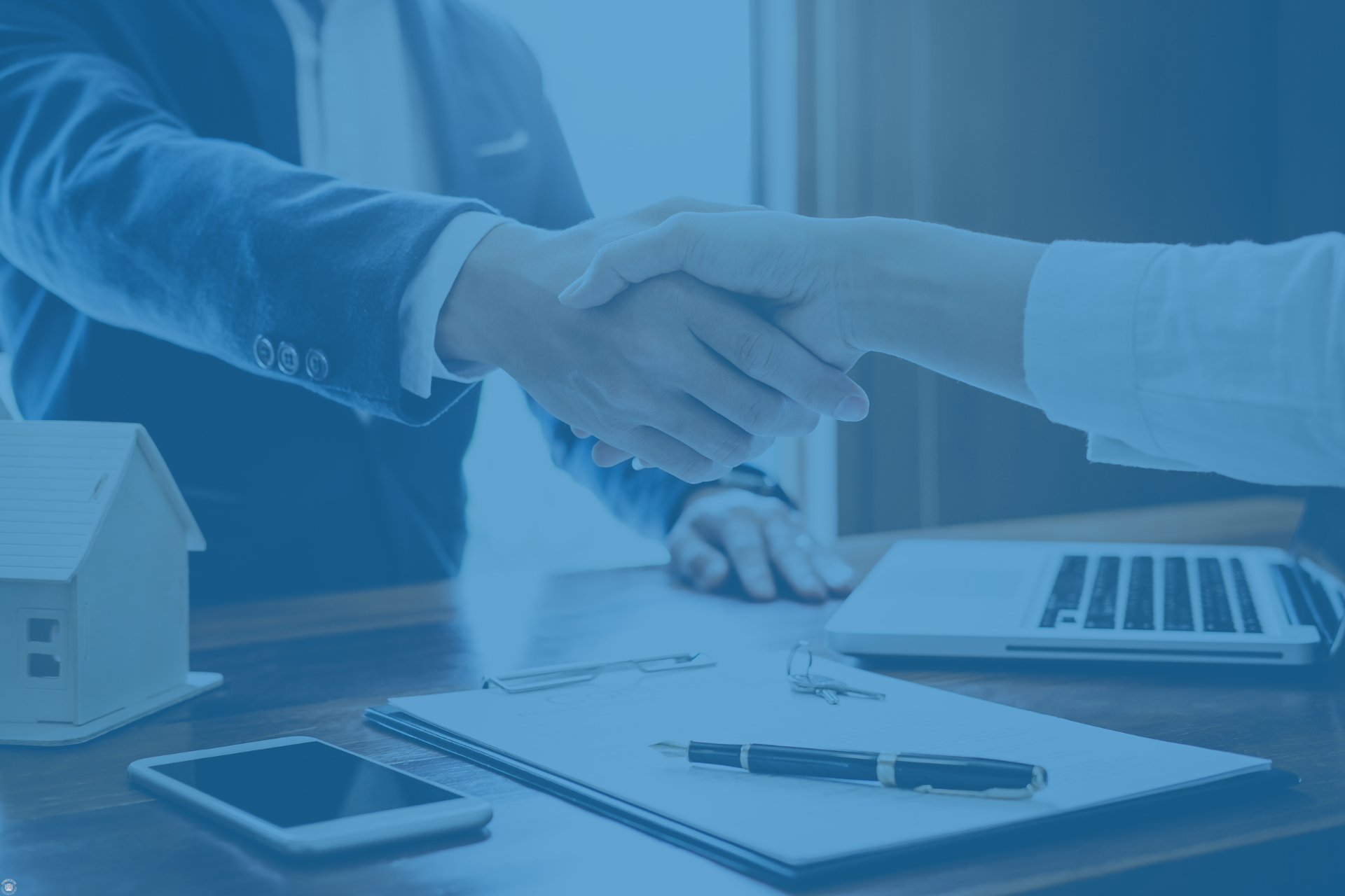 Shaking hands over a business deal, representing technology distributor support and partnership.