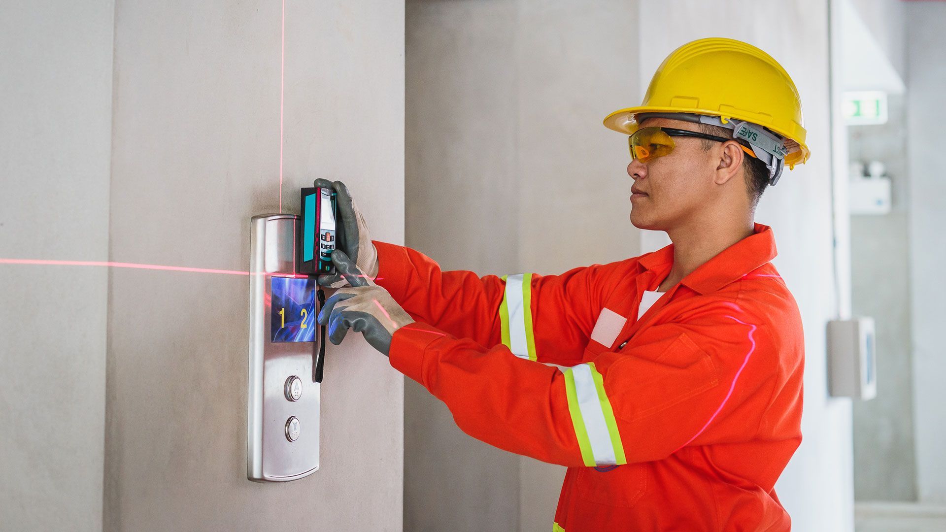Mechanic finishing installation of commercial elevator in Houston Texas.