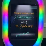 Colorful LED sign reading “Happy Anniversary! Larcher’s and The Belmont Tap to Start”