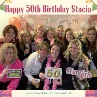 Birthday group posing with signs and balloons, celebrating “Happy 50th Birthday Stacia”