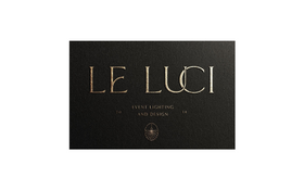 Black logo reading “LE LUCI” on a dark background with small text below