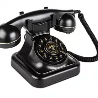 Black vintage rotary dial telephone with handset on base