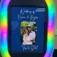 Wedding photo kiosk with rainbow LED frame and couple portrait on a blue screen, “Today’s Start” text