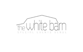 Logo reading “the white barn” in light gray on a white background.