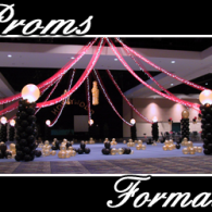 Prom decorations with pink drapes, black balloon columns, and lights in a banquet hall