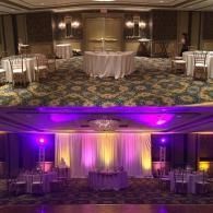 Banquet room setup shown in two lighting styles: warm white above, purple uplighting below.