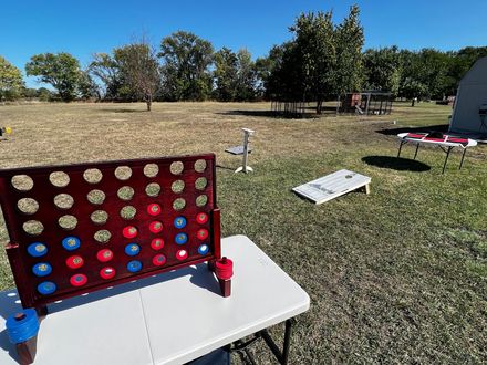 Connect Four game setup on a picnic table in a sunny park