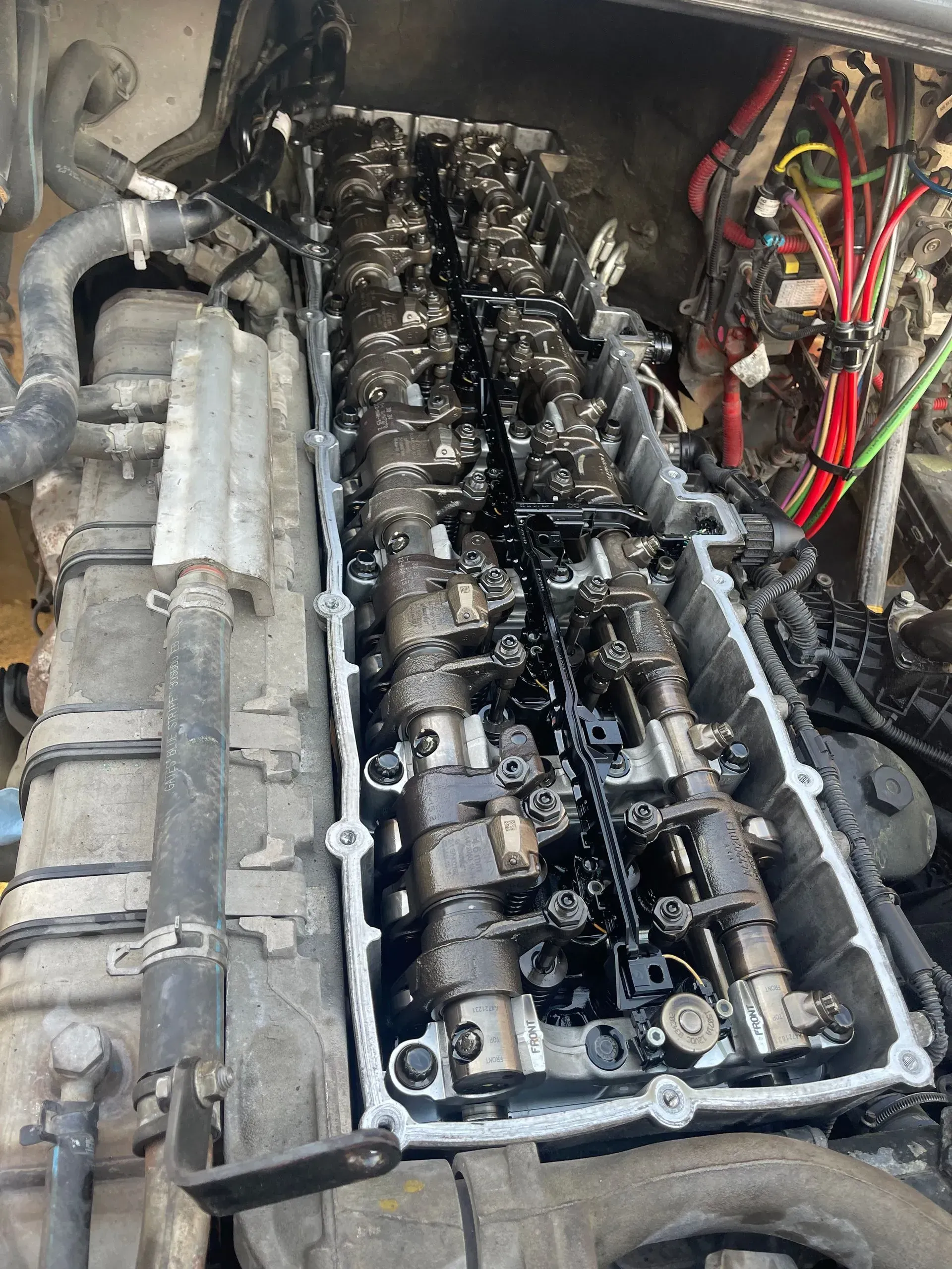 A close up of a car engine with the cylinder head removed.