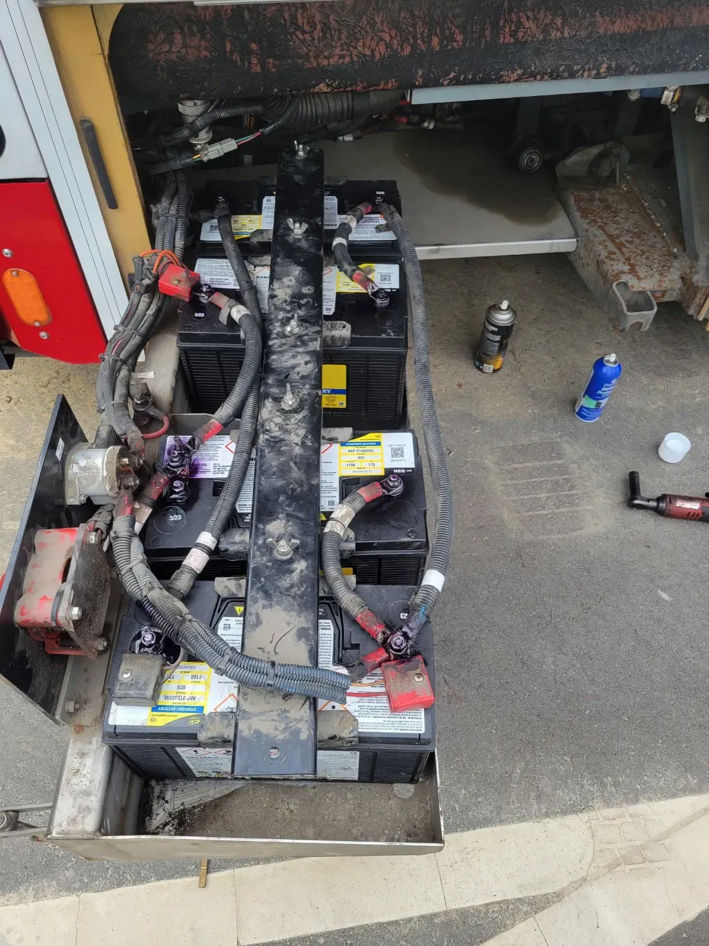 A bunch of batteries are sitting on the ground.