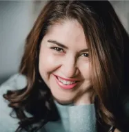 A close up of a woman 's face with a smile on her face