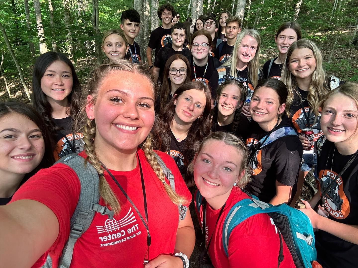 Rogers Explorer kids out on a hike in the woods with Resident Assistants from The Center for Rural Development.