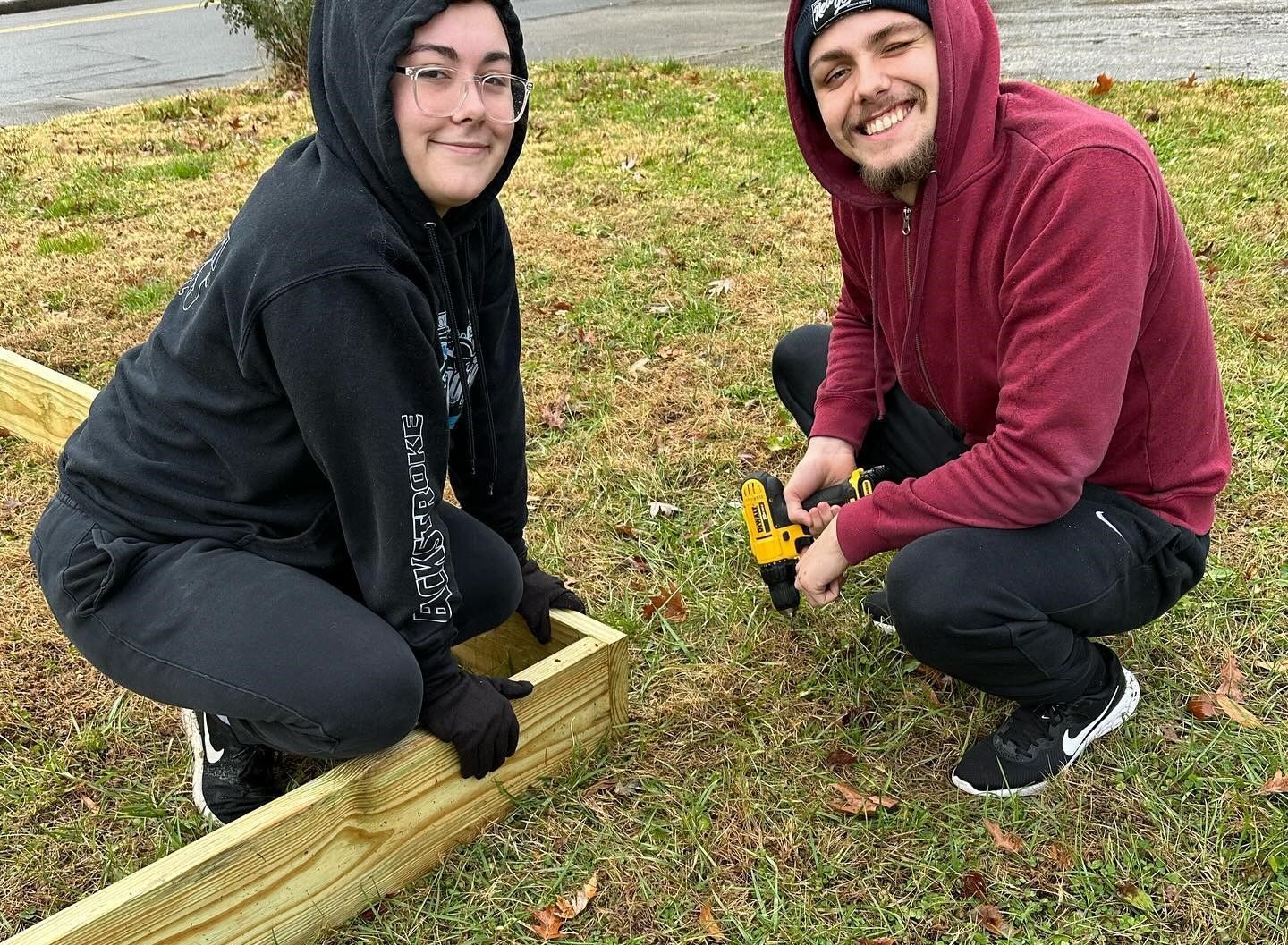 Tehya Laws and Gabriel Icobescu building a raised garden bed.