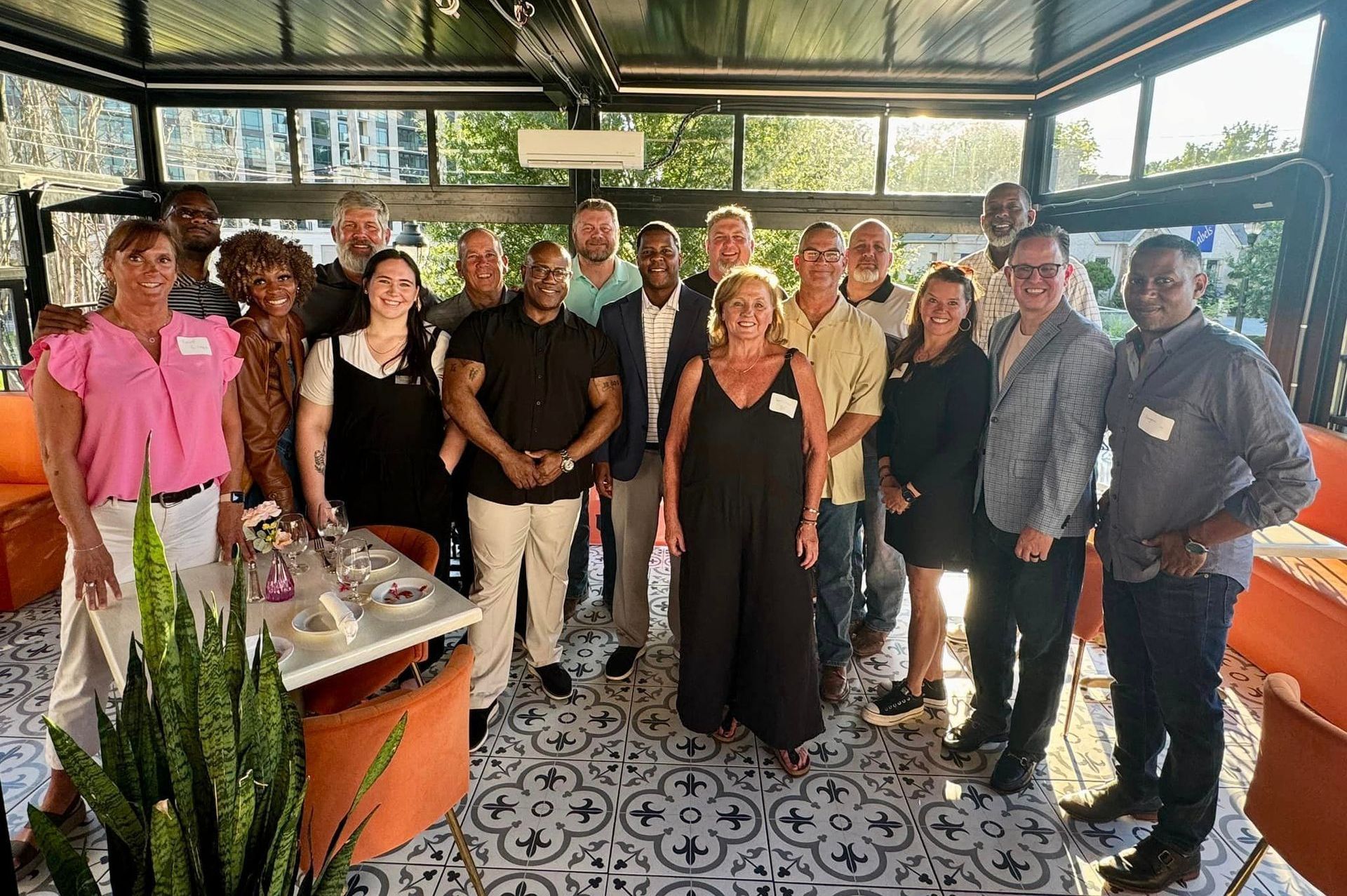 A group of Union alumni pose for a photo during their Atlanta gathering, with Washington standing in the center