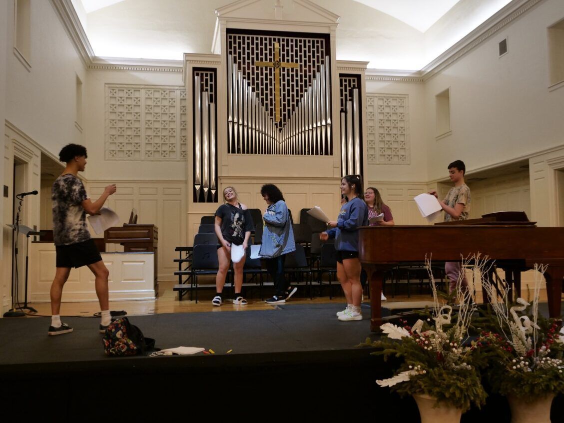 Tyce Hall directing students in a rehearsal.