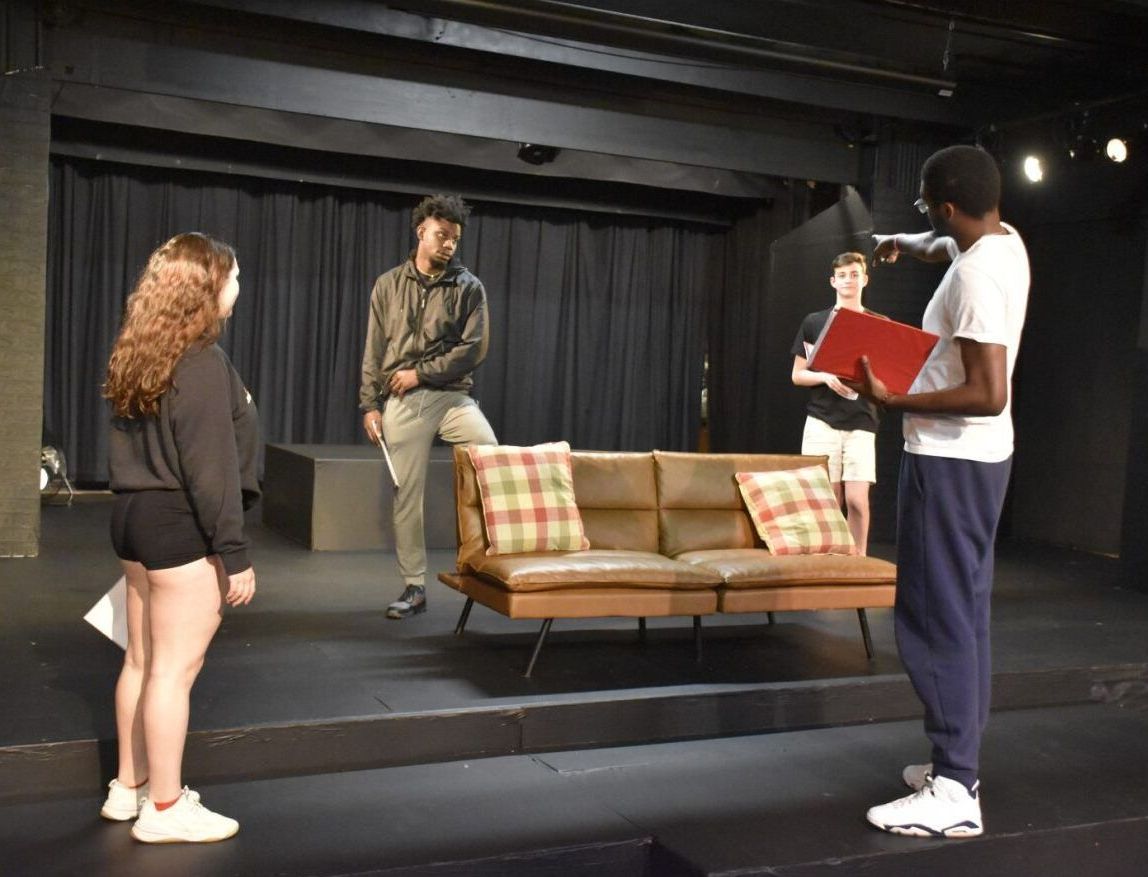 Jay Falls directing actors on stage in the Union Theatre.