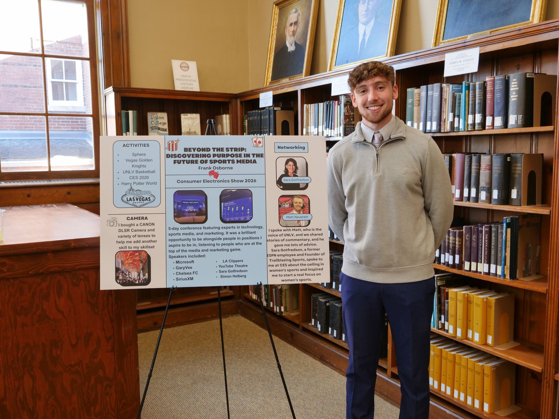 Frank Osborne standing with his poster on his trip to Las Vegas where he explored career opportunities with sports media and journalism.