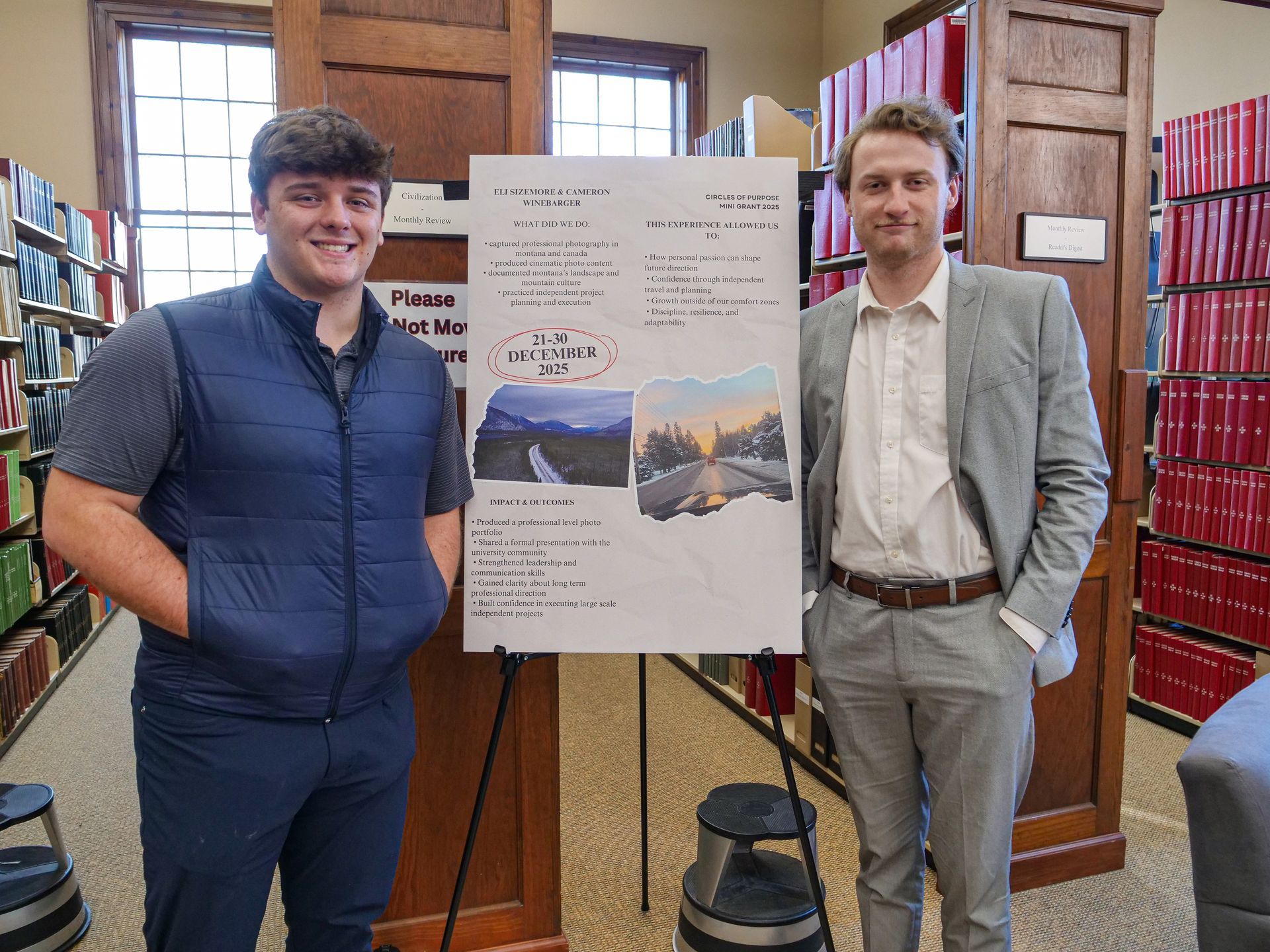 Eli Sizemore and Cameron Winebarger standing with their poster on traveling to Montana and documenting their trip.